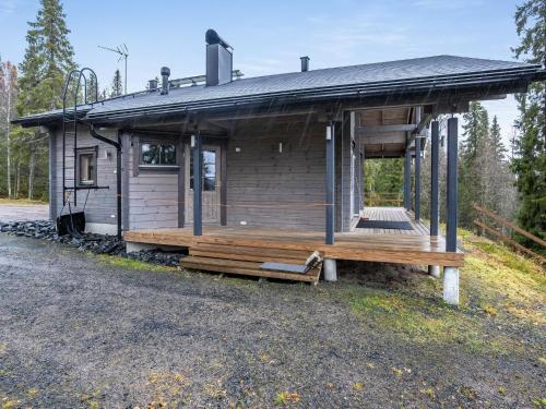 a log cabin with a porch and a bench at Holiday Home Villa helmi by Interhome in Ruka