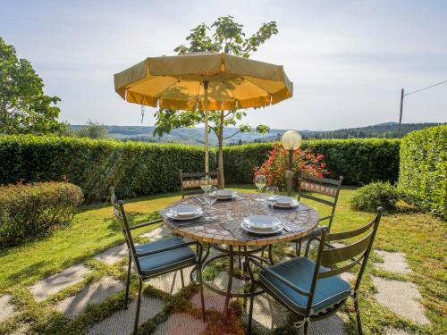 a table with a yellow umbrella and chairs at Holiday Home Al Tramonto - Venere by Interhome in Impruneta