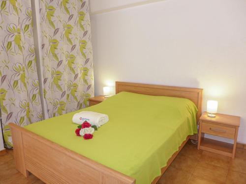 a bedroom with a green bed with a teddy bear on it at Apartment Il était une fois-1 by Interhome in Saint-Aygulf