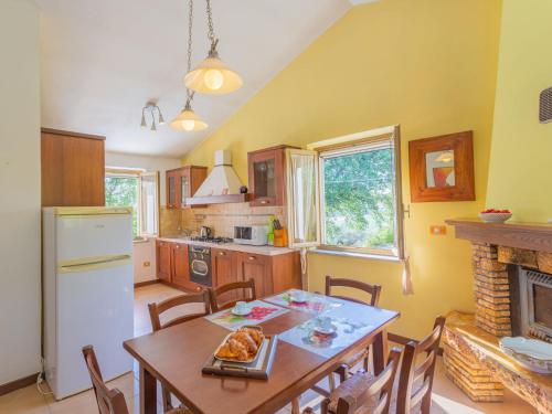 a kitchen with a table and chairs and a fireplace at Holiday Home Le Querce - PIT550 by Interhome in Atri