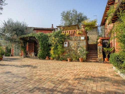 a brick courtyard with plants and a building at Holiday Home Borgo della Limonaia-3 by Interhome in Pieve a Nievole