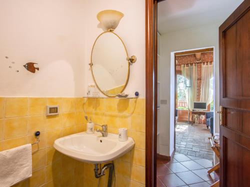 a bathroom with a sink and a mirror on the wall at Holiday Home Borgo della Limonaia-3 by Interhome in Pieve a Nievole
