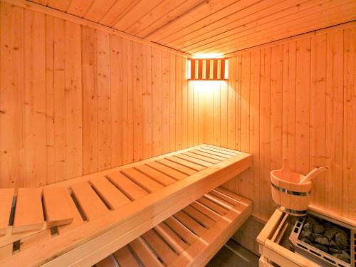 a wooden sauna with a bench in it at Apartment Müritz Ferienpark Röbel-6 by Interhome in Röbel