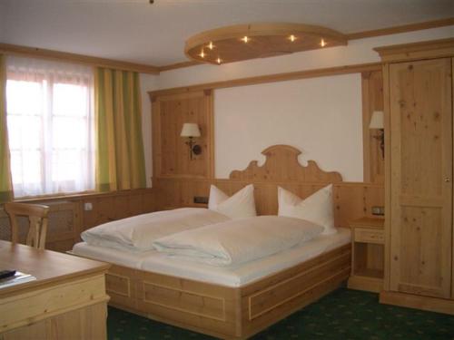 ein Schlafzimmer mit einem großen Bett in einem Zimmer in der Unterkunft Gasthof & Hotel Jägerwirt in Aufhofen