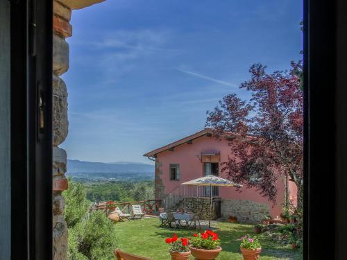 a view of a pink house from a window at Holiday Home Le Poggiole-1 by Interhome in Cavriglia