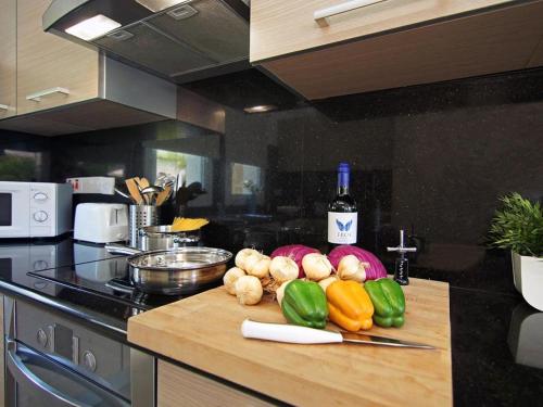 a kitchen counter with vegetables on a cutting board at Villa palm by Interhome in Protaras