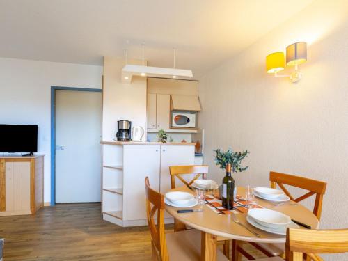 a dining room and kitchen with a table and chairs at Apartment Les Platanes-4 by Interhome in Sainte-Maxime