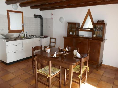 a kitchen with a table and chairs in a room at Holiday Home Rustico L'Hibou by Interhome in Corzoneso