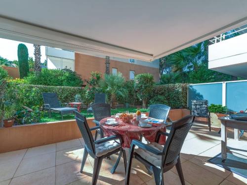 a patio with a table and chairs on it at Apartment Le Domaine de la Baie-3 by Interhome in Cavalaire-sur-Mer