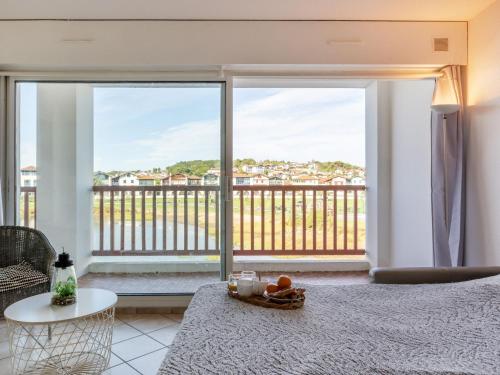 a bedroom with a bed and a large window at Apartment Ederra Untxin by Interhome in Socoa