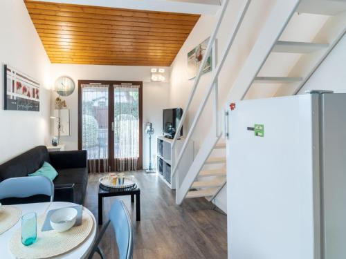 a living room with a couch and a refrigerator at Holiday Home lotissement Les Rives de Capbreton by Interhome in Capbreton