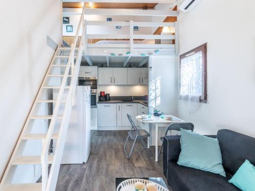 a living room and kitchen with a loft bed at Holiday Home lotissement Les Rives de Capbreton by Interhome in Capbreton