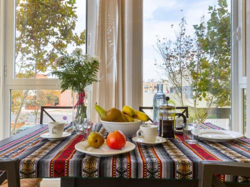 a table with a plate of fruit on it at Apartment Carnaval by Interhome in Isla Cristina