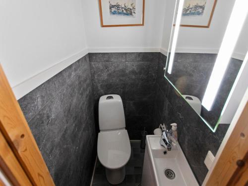 a small bathroom with a toilet and a sink at Holiday Home Kätkäläinen e 2 by Interhome in Sirkka