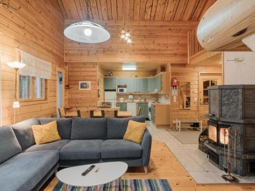 a living room with a couch and a stove at Holiday Home Kevätruska b by Interhome in Sirkka
