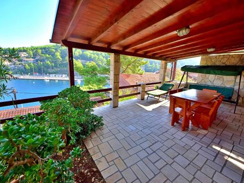 a patio with a table and a view of the water at Holiday Home Peter by Interhome in Prigradica
