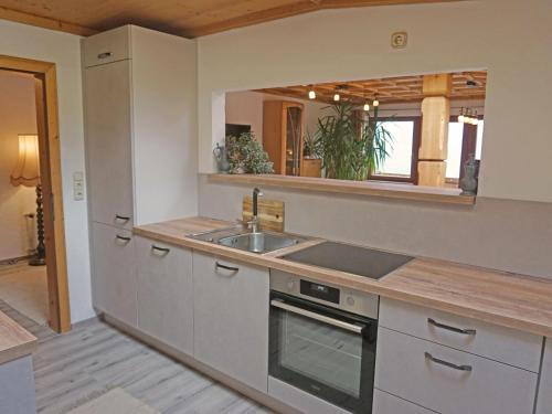 - une cuisine avec un évier et un comptoir dans l'établissement Apartment Romantik Chalet Karin-3 by Interhome, à Sellrain