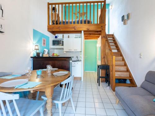 a kitchen and dining room with a table and a staircase at Holiday Home Plage sud-3 by Interhome in Capbreton