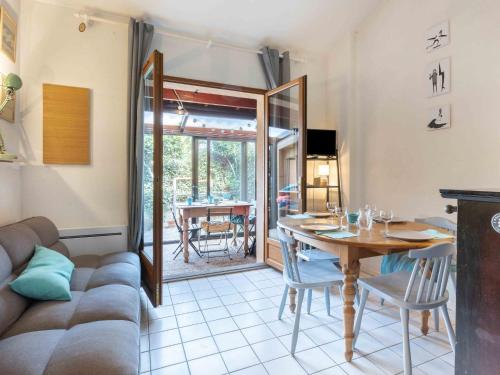 a living room with a table and a couch at Holiday Home Plage sud-3 by Interhome in Capbreton