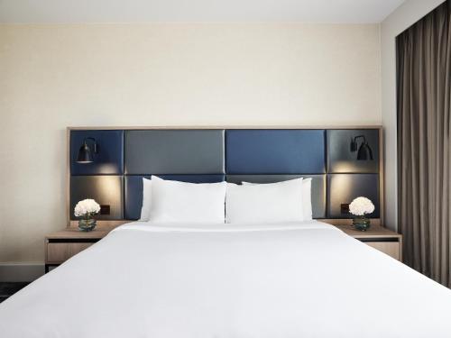 a large bed in a hotel room with white pillows at Hyatt Regency Manchester in Manchester