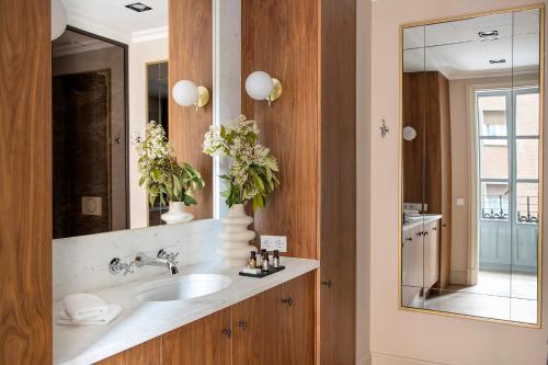a bathroom with a sink and a mirror at Ayala 63 - THE ARC COLLECTION in Madrid