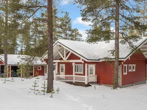 a red cabin in the snow with trees at Holiday Home Petsukantähti by Interhome in Sirkka