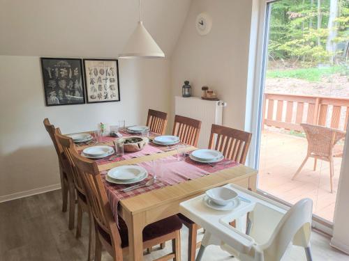 a dining room with a table and chairs and a table and chairsktop at Chalet Waldoase by Interhome in Bad Arolsen
