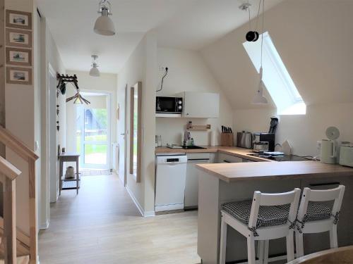 a kitchen with a counter and some chairs in it at Chalet Waldoase by Interhome in Bad Arolsen