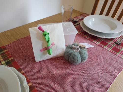 a table with a gift bag and a cat figurine on it at Chalet Waldoase by Interhome in Bad Arolsen