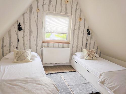 a bedroom with two beds and a window at Chalet Waldoase by Interhome in Bad Arolsen