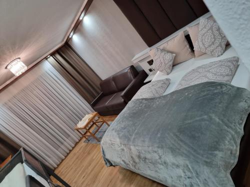 a bedroom with a large bed and a couch at Haiminger Hof in Haiming