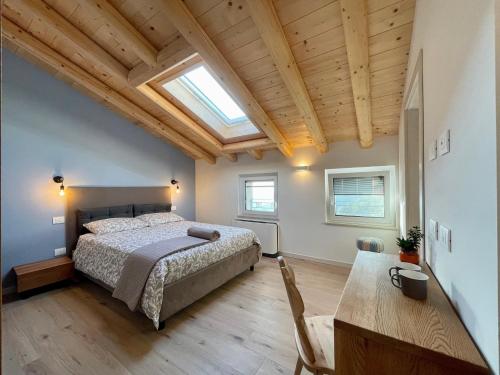 a bedroom with a bed and a wooden ceiling at Corte Baccoi in Rovere Veronese