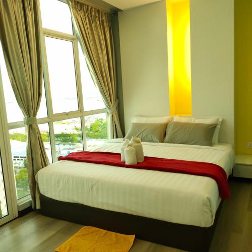a bedroom with a large bed with two teddy bears on it at Penang Studio Suite in Georgetown in George Town