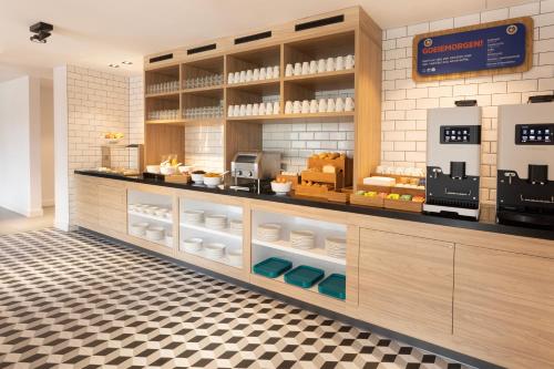 a bakery with a counter with food on it at Holiday Inn Express & Suites - Deventer by IHG in Deventer