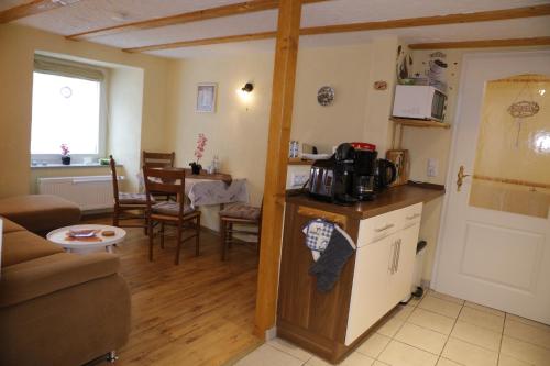 eine Küche und ein Wohnzimmer mit einem Sofa und einem Tisch in der Unterkunft Moselwinzerhaus in Bruttig-Fankel