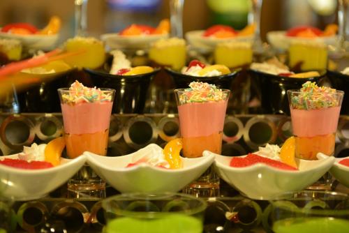 a group of cups filled with different colored desserts at Manaspark Deluxe Hotel in Oludeniz