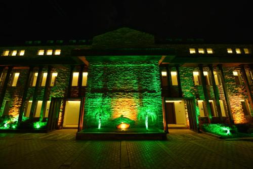 a building with green lights in front of it at night at Manaspark Deluxe Hotel in Oludeniz