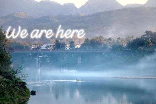 a quote that says we are here on a lake at Moonlight Champa Riverview in Luang Prabang