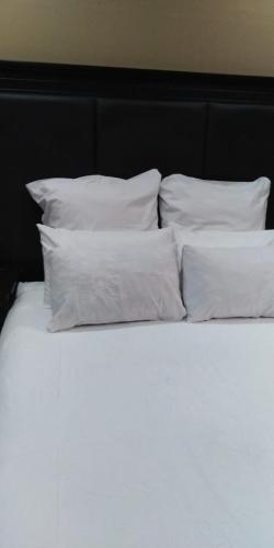 a white bed with white pillows on top of it at VIP Deluxe Restroom Zone in Durban