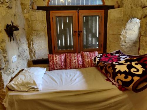 a bed sitting in a room with a window at Tunis Lake View in ‘Izbat an Nāmūs