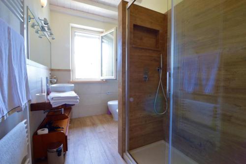 a bathroom with a shower with a glass door at La Sassaiola by Nicola Real Estate in Corsanico-Bargecchia
