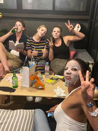 a group of people sitting around a table at Zzzip Guesthouse in Hongdae in Seoul