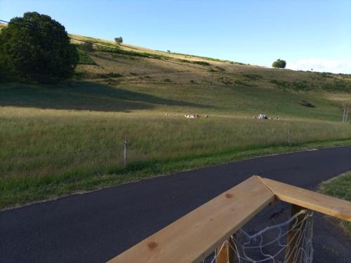 a wooden railing on the side of a road at Gîte l'estive du Clozel in Besse-en-Chandesse