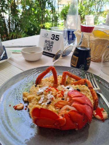 a plate of food with a lobster on it at La Bussola Hotel Calabria in Capo Vaticano