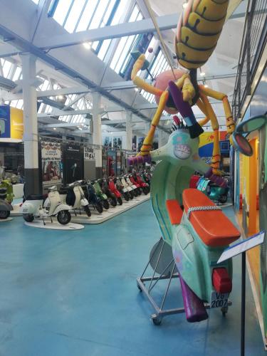 a room with a toy motor scooter on display at Casolare Isabella "Il rifugio dei vinili" and Alice's room in Ponsacco