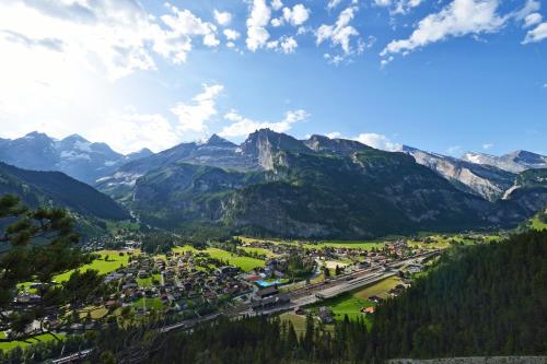 a town in a valley with mountains in the background at Toni's Alpine Loft & SPA in Kandersteg