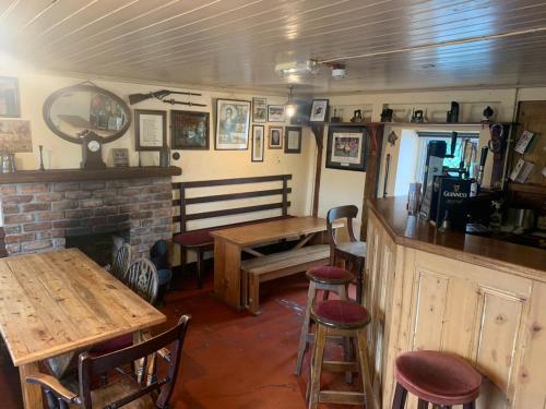 a restaurant with a table and chairs and a fireplace at Billy Andys in Glenoe