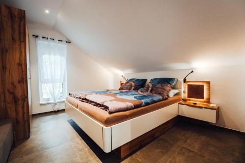 a bedroom with a large bed with blue pillows at Ferienwohnungen Am Heidegarten in Schneverdingen