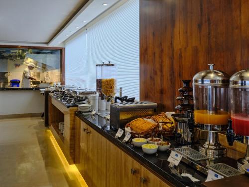 a kitchen with a counter with some food on it at Essentia Premier Hotel, Chennai in Chennai