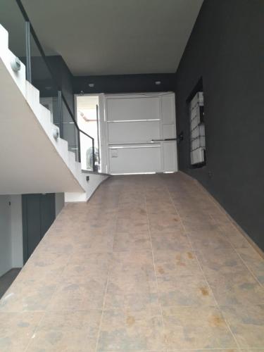 an empty room with a staircase and a tile floor at Alquiler temporario in Tandil